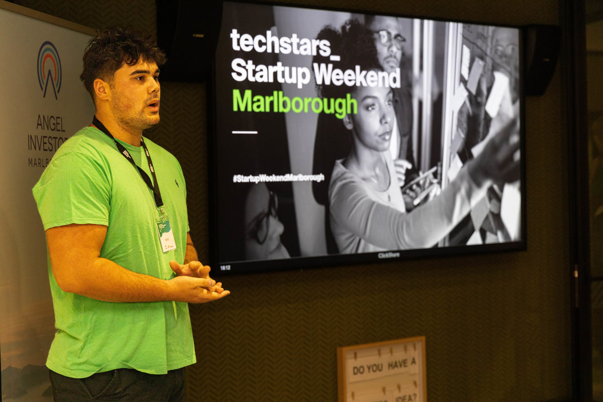 A presenter addresses the audience of the Techstars Startup Weekend 