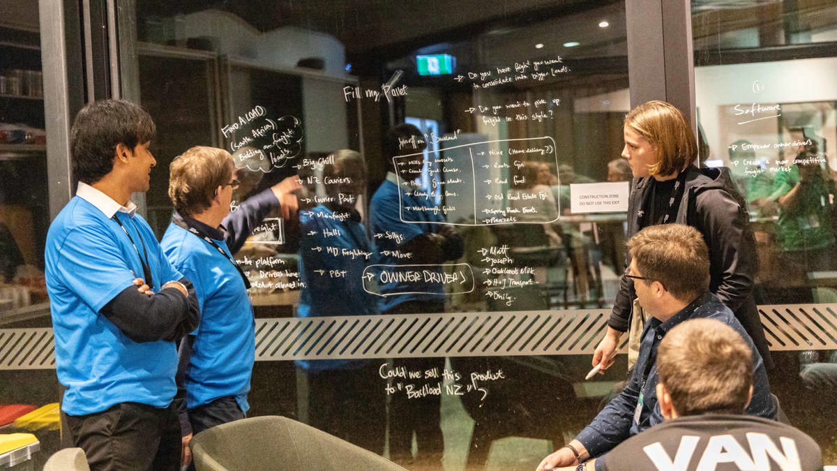 Workshop participants brainstorm their ideas using a window as a whiteboard