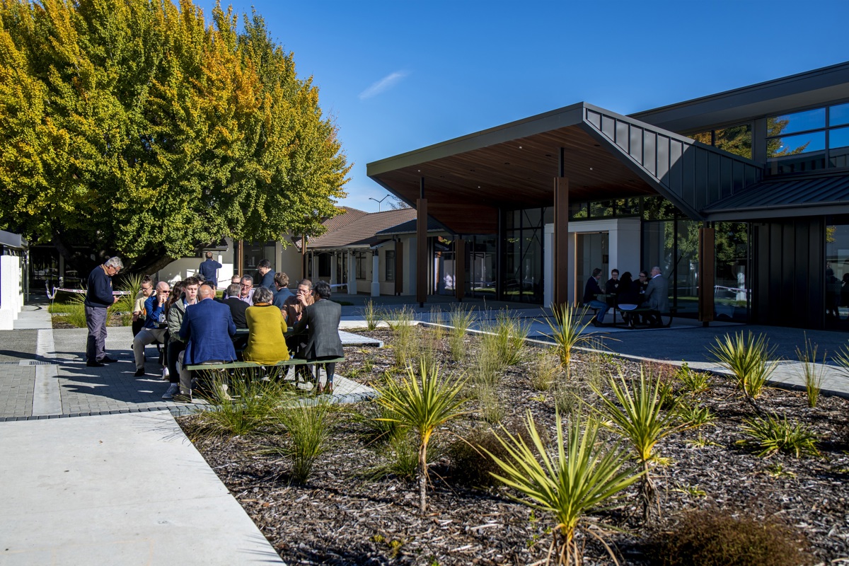 Businesspeople sitting outdoors at table having a break